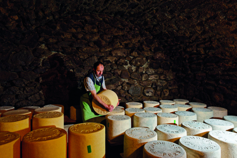Turning the hefty wheels of Salers cheese in Cantal is no easy task but it's essential to the maturing process.