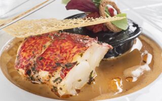 Lobster served hot and cold with lobster claw and squid ink ravioli