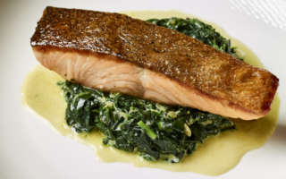 Pan-fried salmon with spinach, watercress and Saint Agur blue cheese sauce