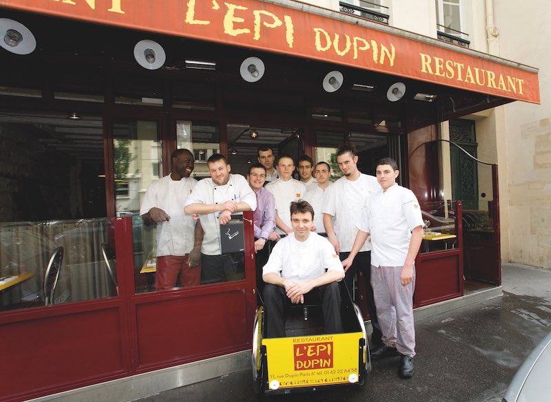 Service crew from the L'Epi Dupin restaurant, head chef Francois Pasteau seated in a wagon,