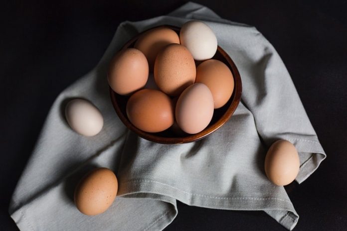 Eggs on a grey cloth on a black table