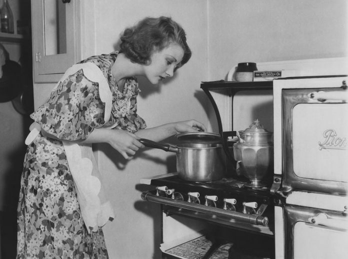 Black and white image of housewife cooking