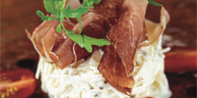 Remoulade of celeriac with Savoie ham and basil oil
