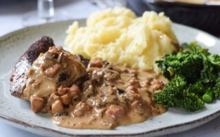 Wild boar steaks with prunes, pancetta and brandy