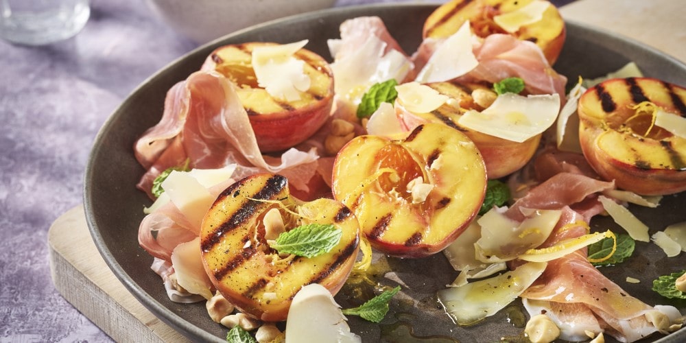 Burnt peaches with Comté, prosciutto and hazelnuts