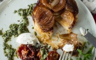 Shallot tarte tatin with goat’s cheese, roasted cherry tomatoes and watercress salsa verde