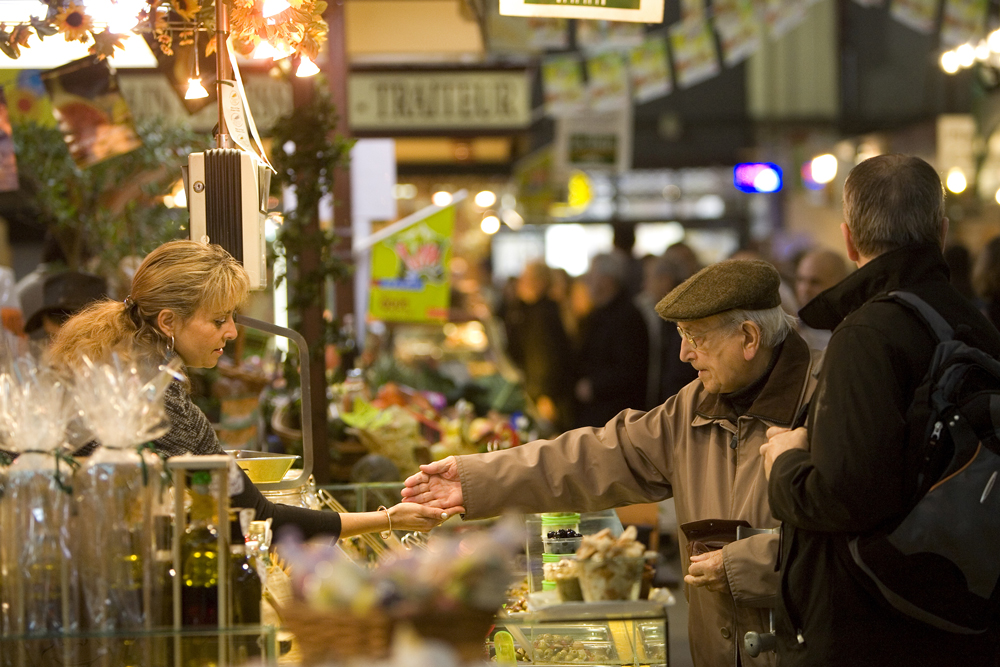 An old man paying at the Narbonne Market