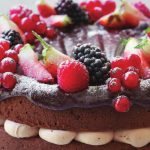 Chocolate cake with icing and berries