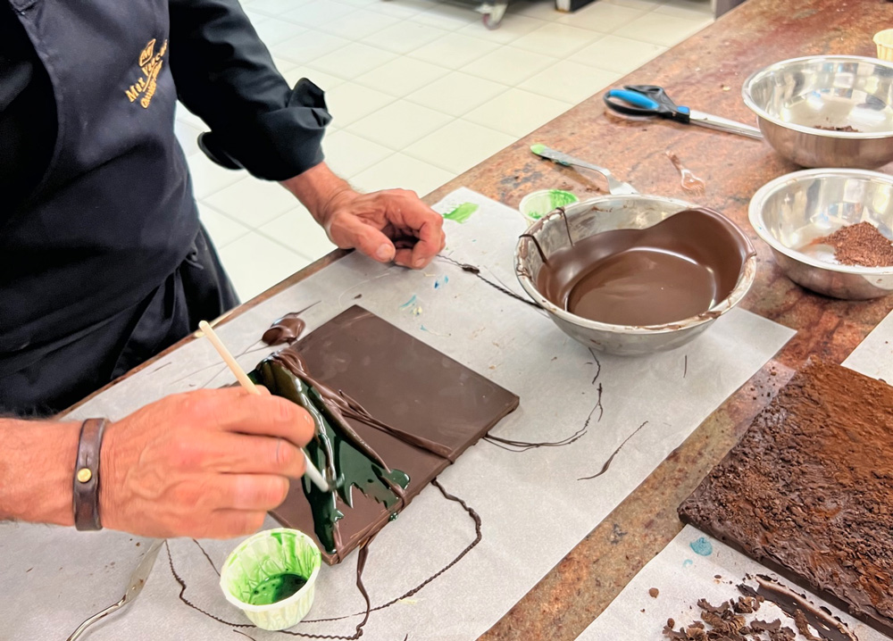 Man painting chocolate with green paint