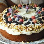 Frosted Pistachio Cake topped with berries and lavender