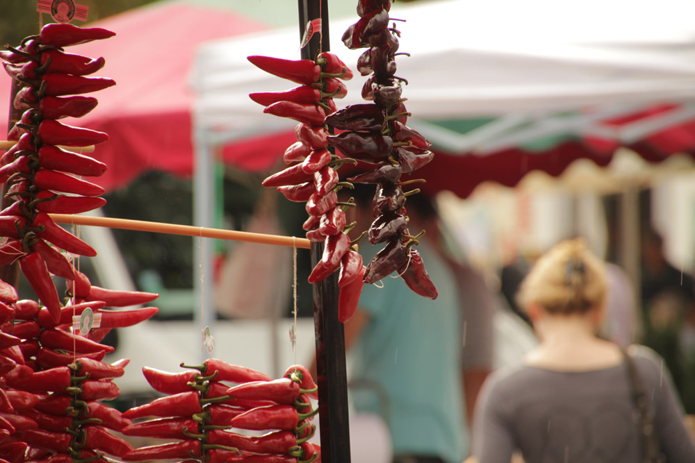 A bunch of chillis dangling in a French market