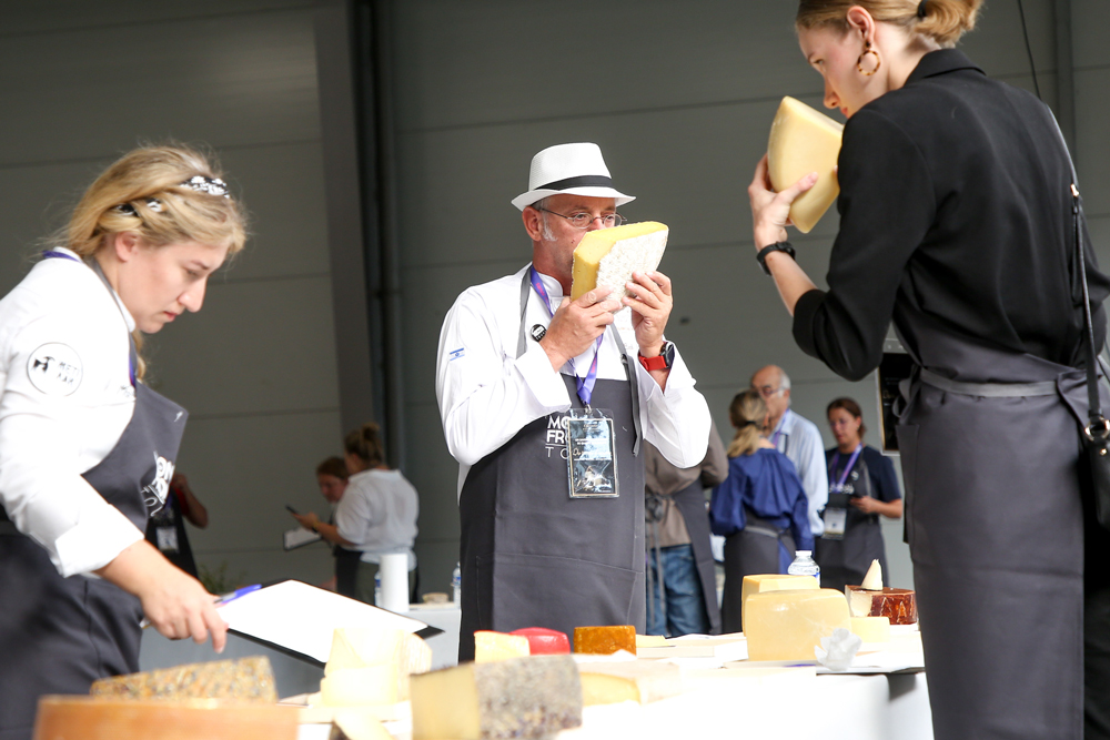 People smelling and checking cheese