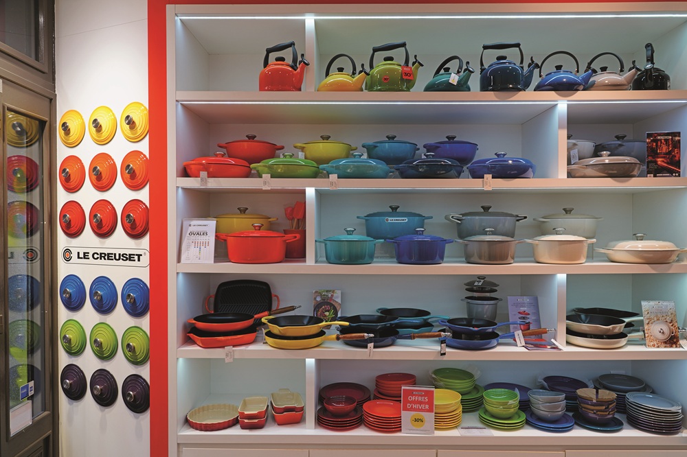 View of colorful enameled pots and pans in a Le Creuset store, an expensive brand of French kitchenware.
